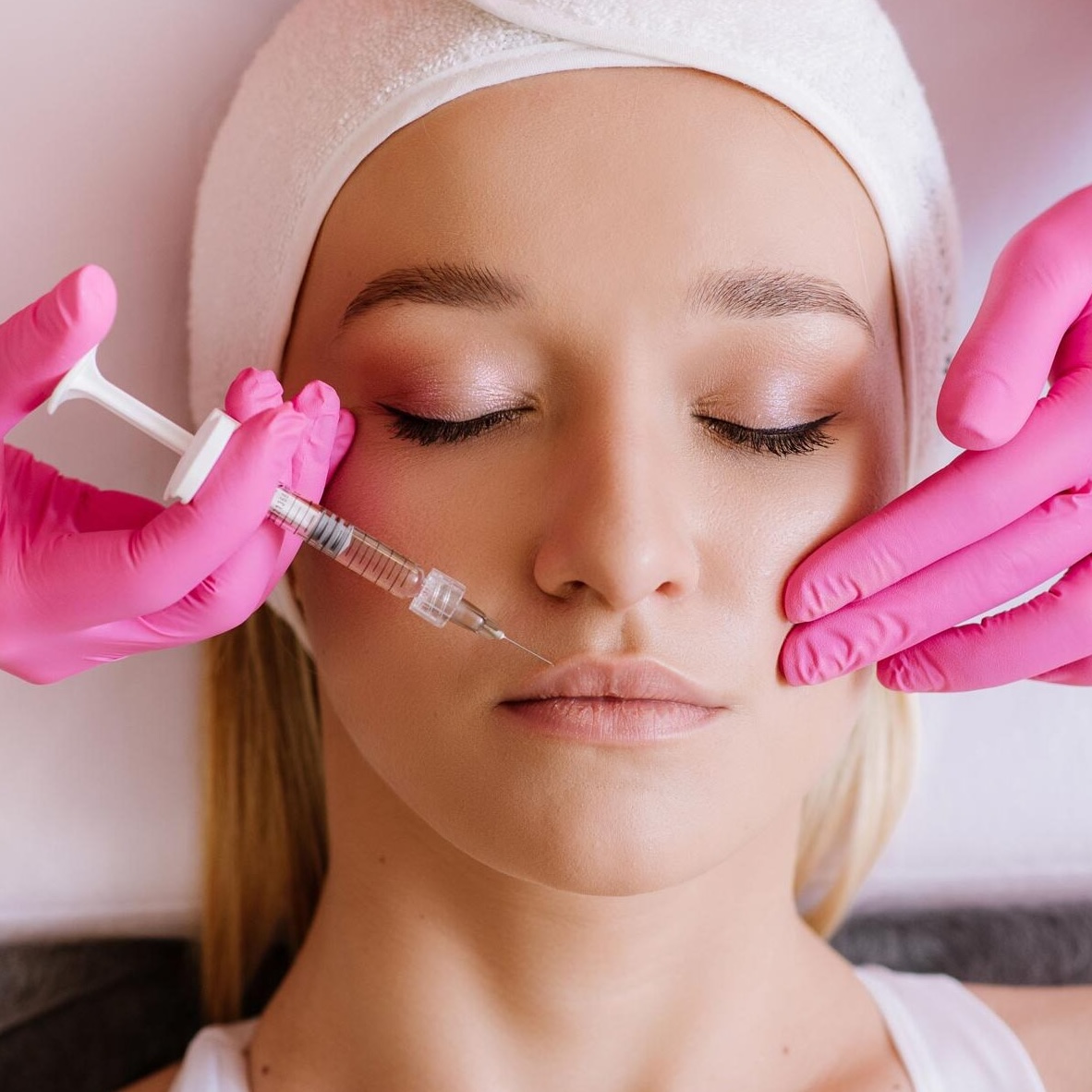 Person receiving cosmetic treatment procedure.